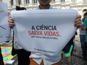 Cartaz exibido na Marcha pela Ciência de Curitiba com as frases "A ciência salva vidas. Sem ciência não há futuro" 